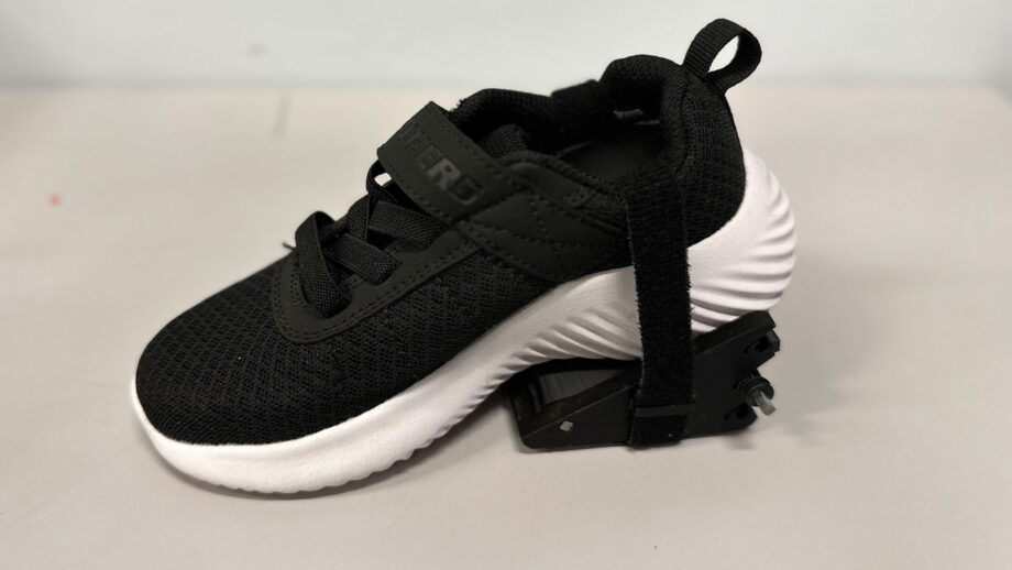 A 3d printed wedge attached to the heel of a shoe.