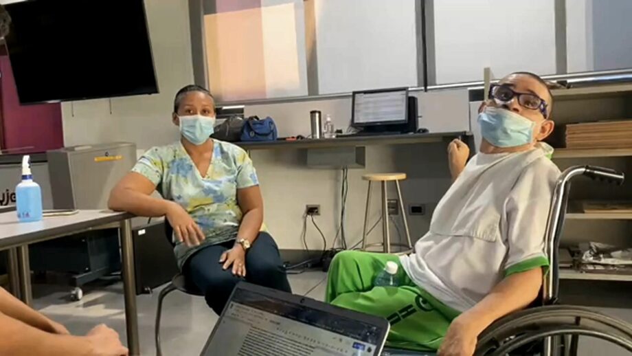 A team interviewing a Make:able end user in a wheelchair.