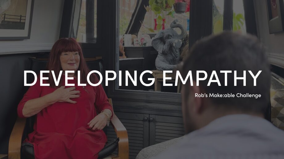 Make:able Champion, Cath, sat on a chair talking to PrintLab's Lead Designer, Rob. The title 'Developing Empathy' overlaid in white bold text.