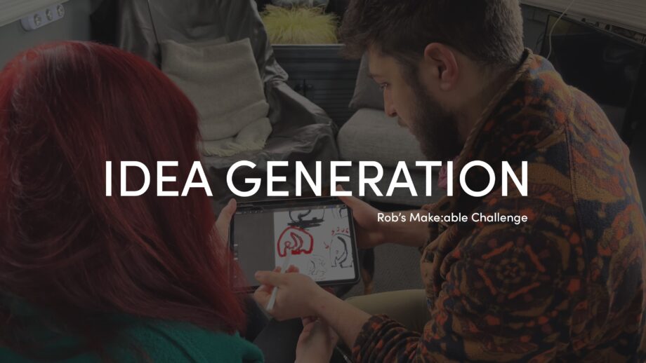 PrintLab's lead designer, Rob, showing Cath some sketch ideas of an elephant fidget device on an iPad. The title 'Idea Generation' is overlaid in white bold text.