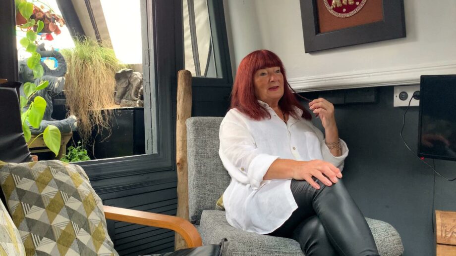 Make:able Champion, Cath, sat on a grey chair.