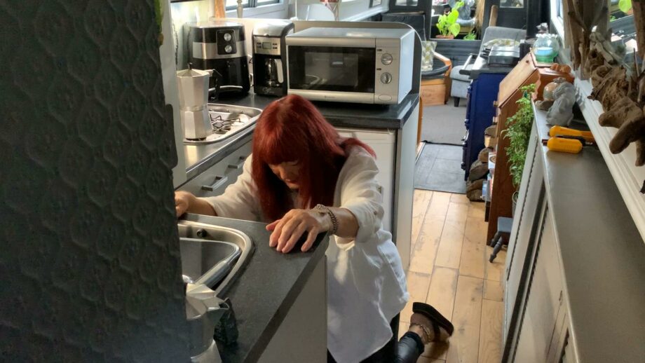 Make:able Champion, Cath, kneeling on her kitchen floor.