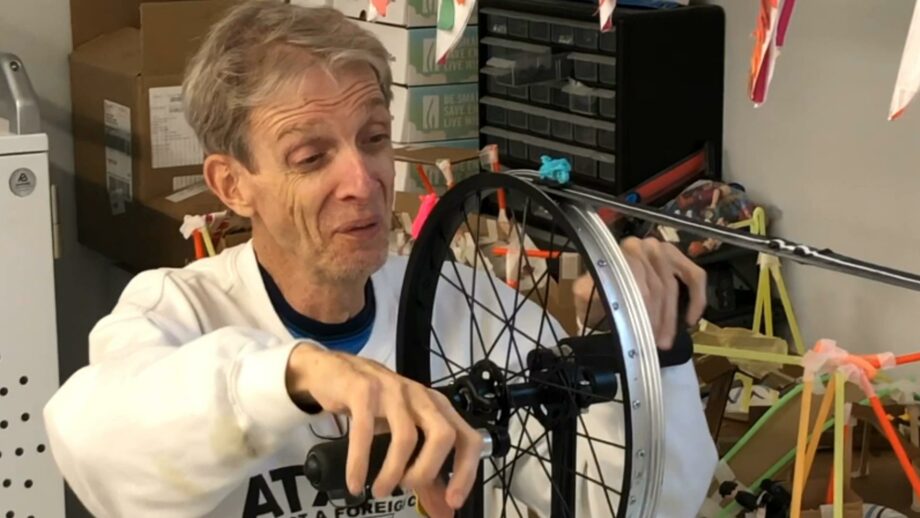 A person using a sight therapy device, which uses a bicycle wheel in conjunction with 3D printed passion objects.
