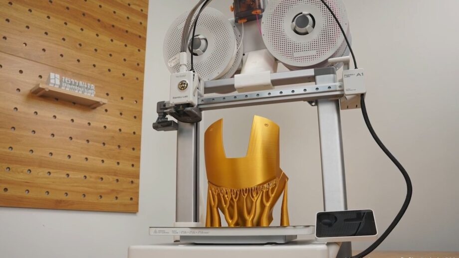 The Bambu Lab A1 3D printer creating a cosplay item in gold filament.