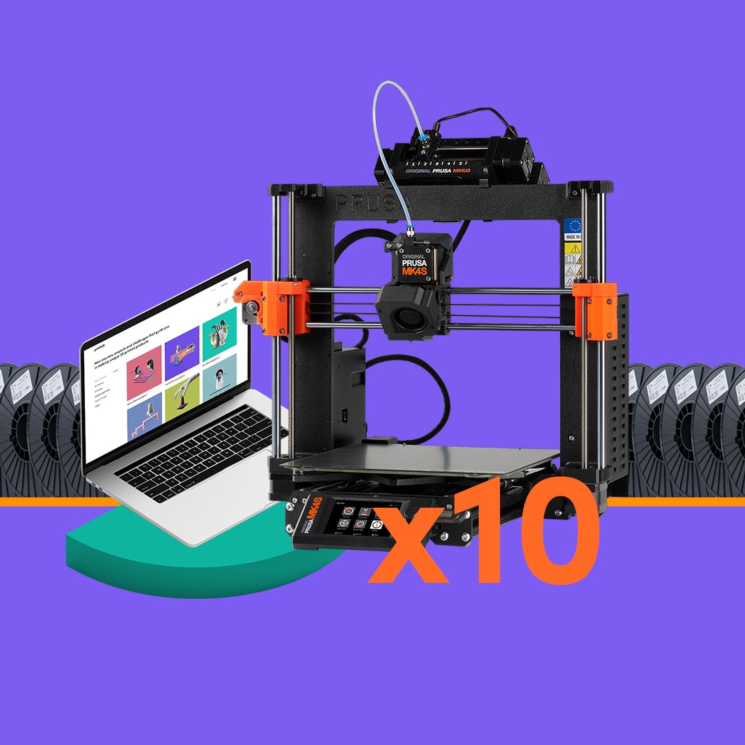Prusa MK4S 3D printer with ‘x10’ written over the top, beside a laptop displaying the PrintLab 3D printing curriculum. 20 reels of Jessie Premium PLA are in the background.
