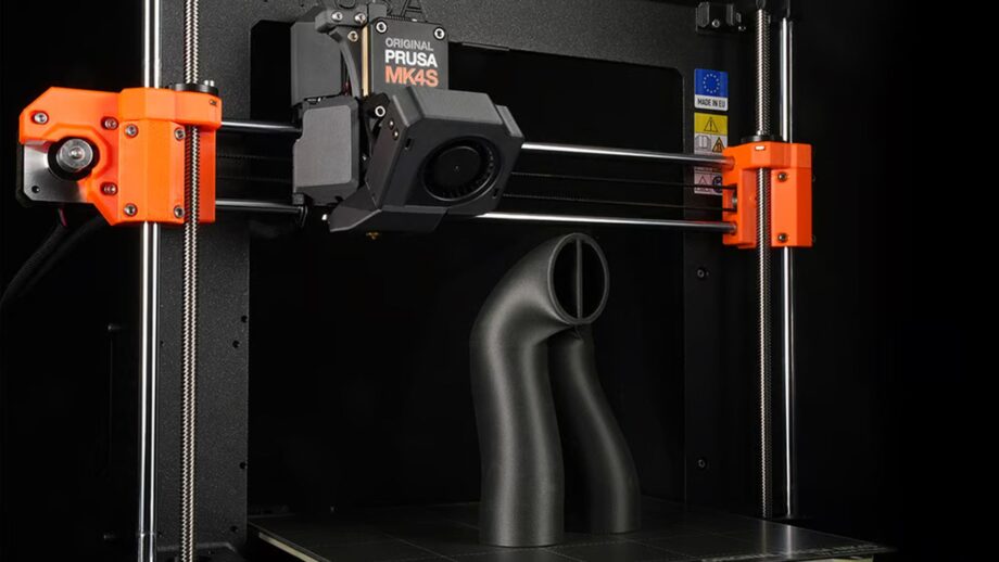 A black engineering 3D print on the Prusa MK4S print bed.