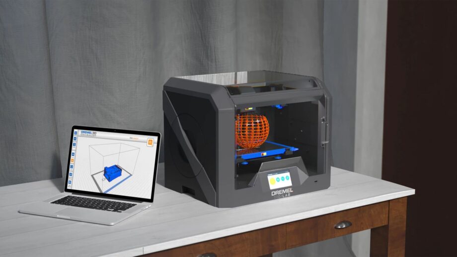 Dremel 3D45 3D printer on a desk with a laptop beside it.