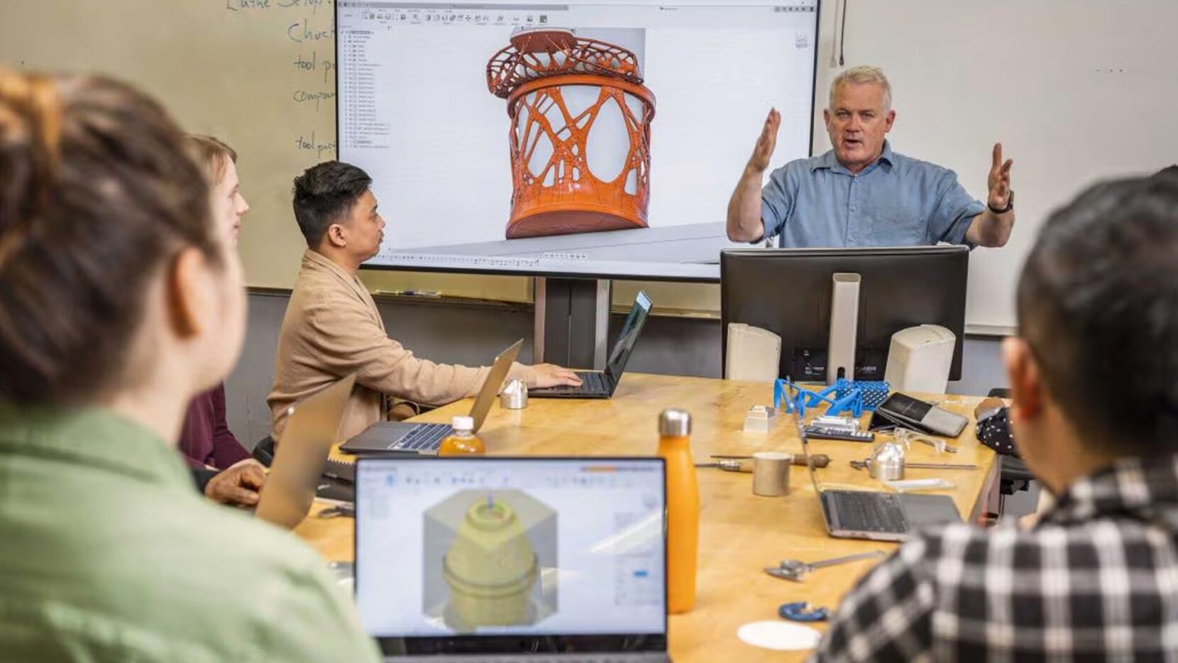 An Autodesk instructor delivering a Fusion training session to students.